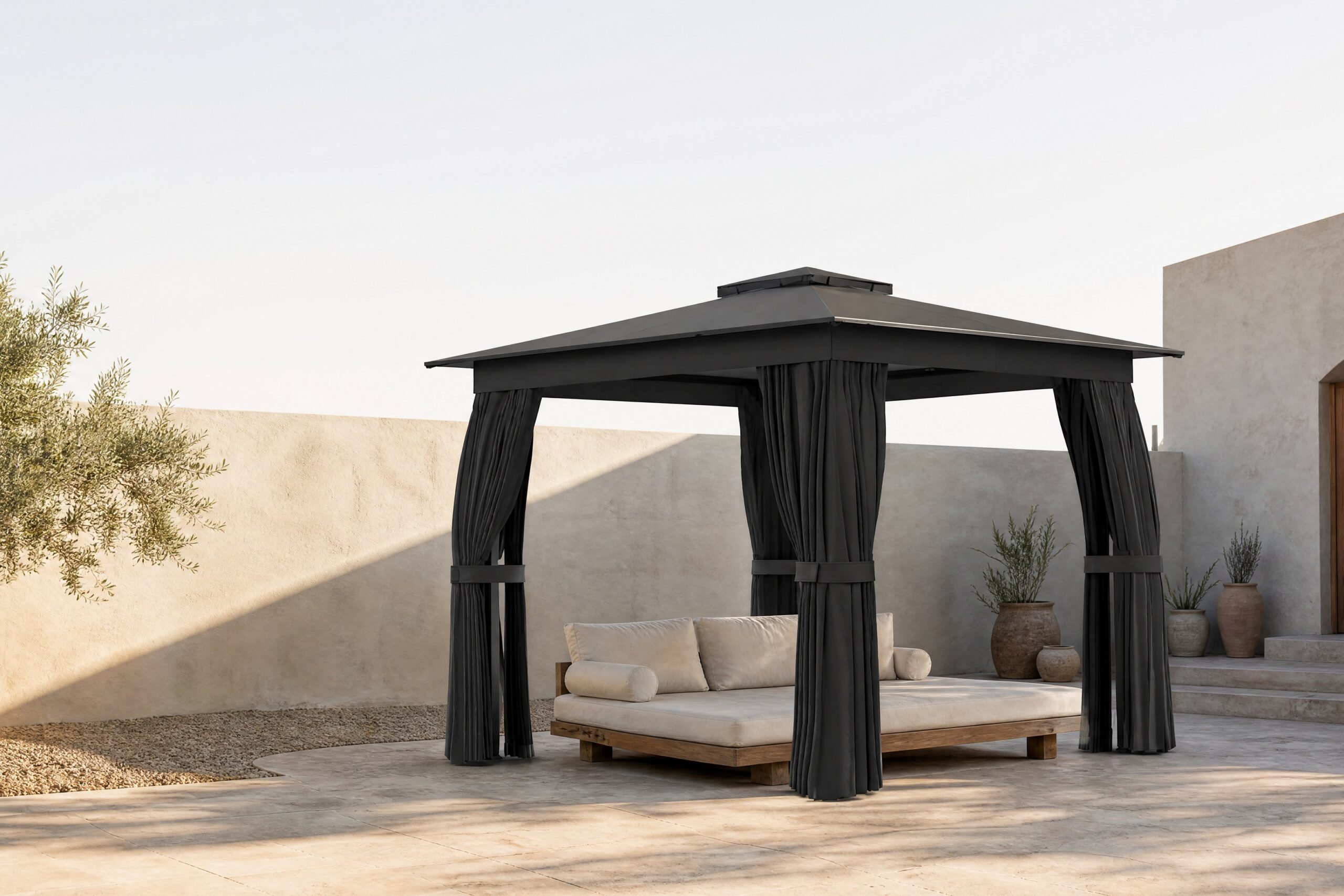 The Retreya Pavilion, a 10x10 garden gazebo with a double-tier roof, on a travertine courtyard at golden hour